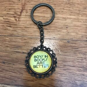 “Boys in books are better” brass Art Deco sunflower bottlecap keychain